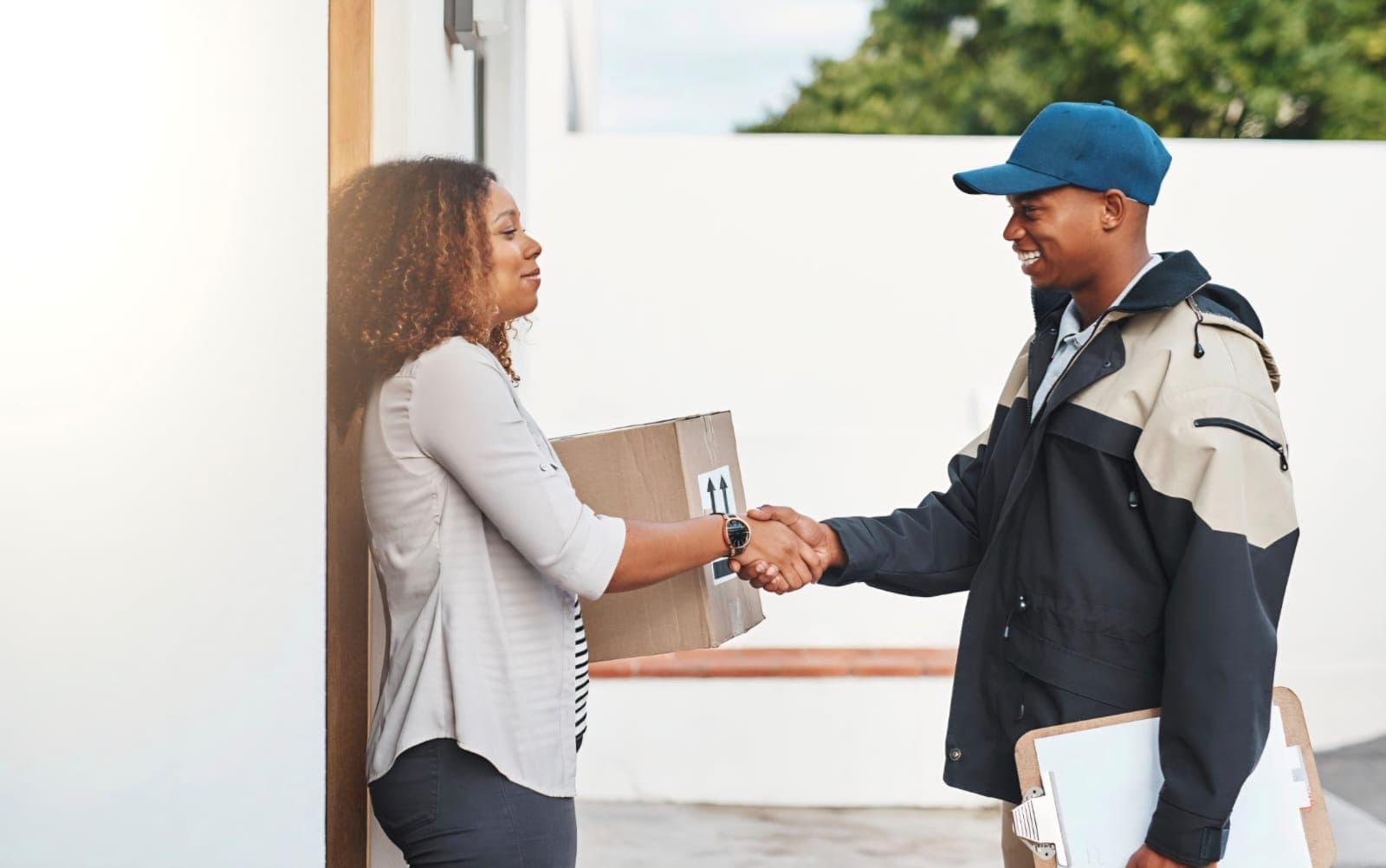 Mercury Services driver handing a delivered parcel to a satisfied customer